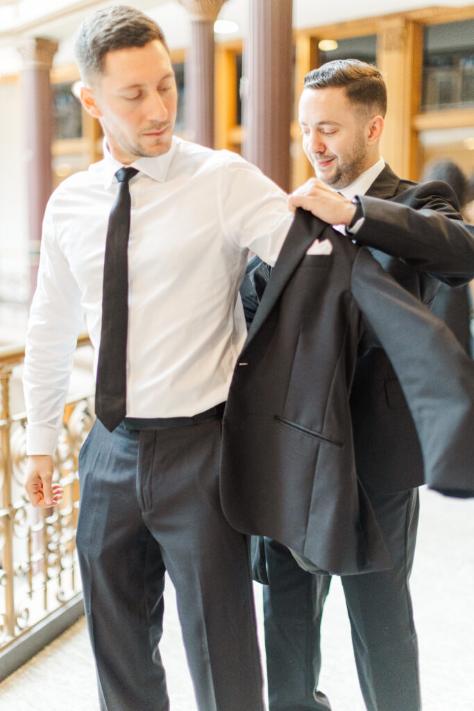 Groom getting ready at the Hyatt at the Arcade before a Cleveland wedding